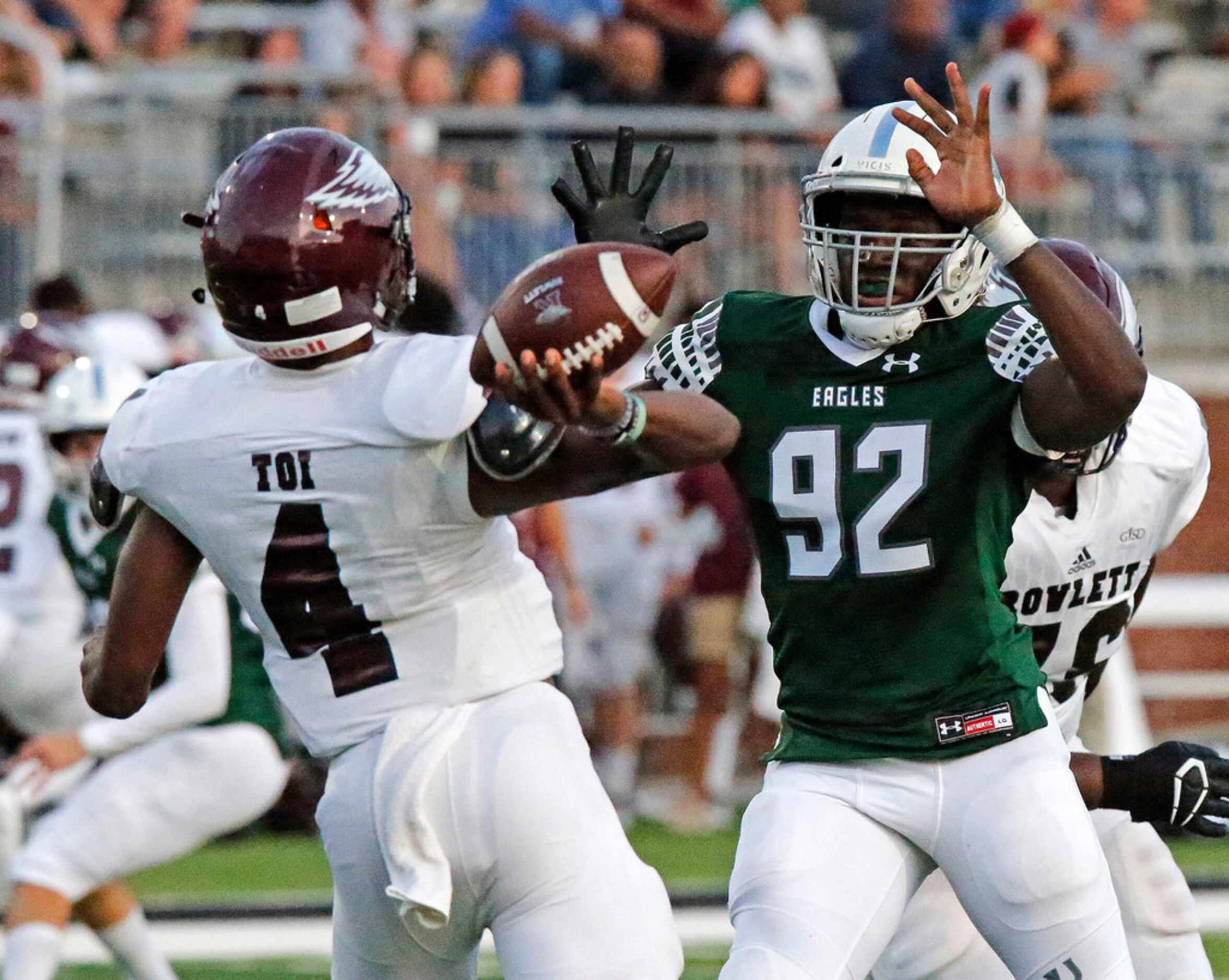 Rowlett High School quarterback Alex Routt (4) is hurried by Prosper High School defensive...