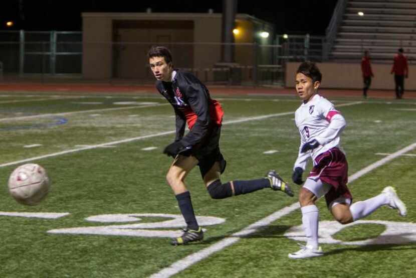 
Lewisville’s Van Cung (right) fights Coppell senior Kellen Reid for position on the ball...