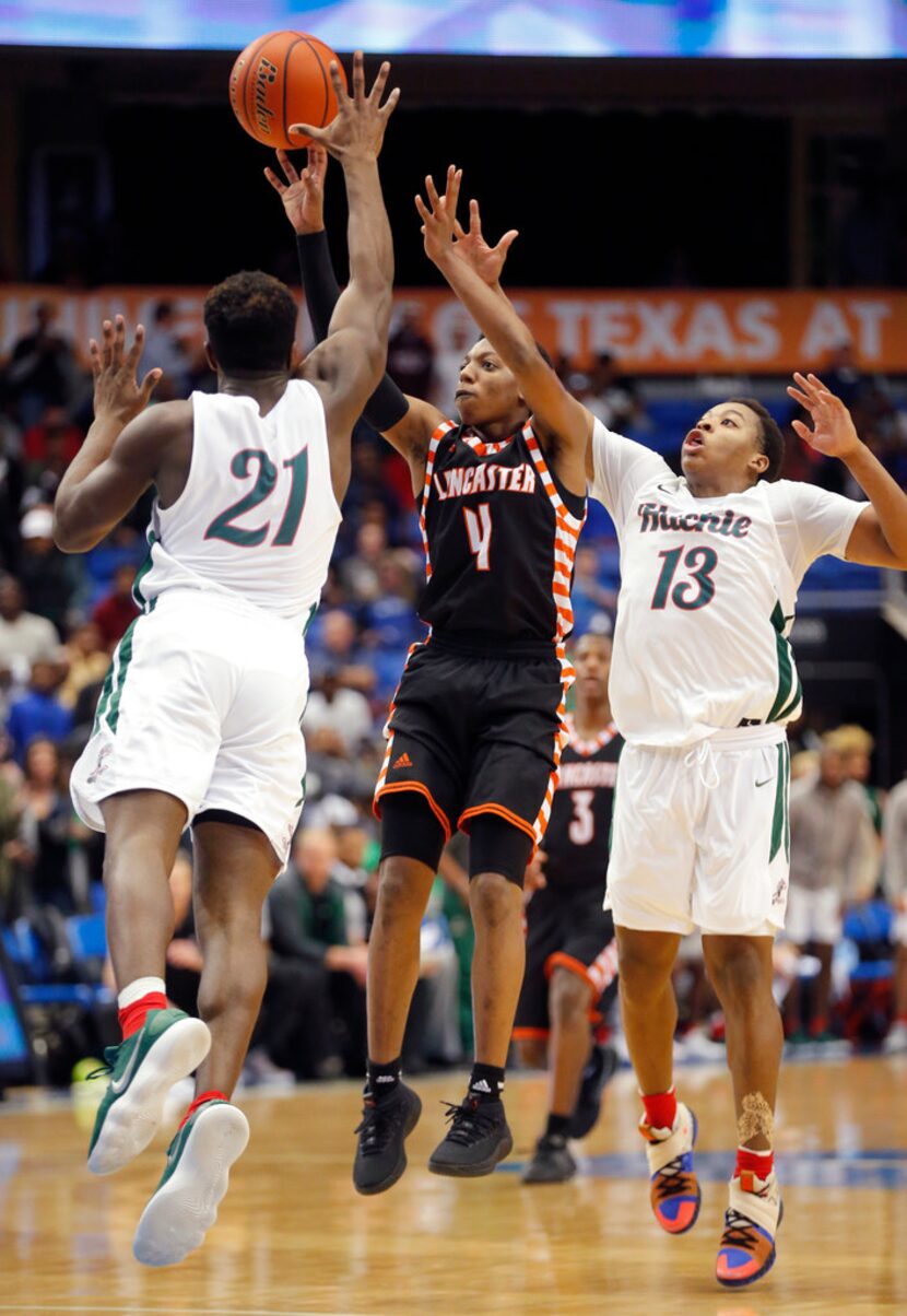 Lancaster Wade Taylor (4) attempts a three-point shot as Waxahachie junior guard Demani...