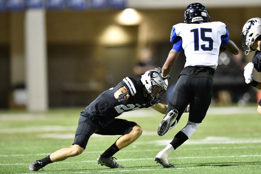 Guyer junior defensive back Cade Ford (23) tackles Nelson junior Calvin Wiggins (15) at C.H....