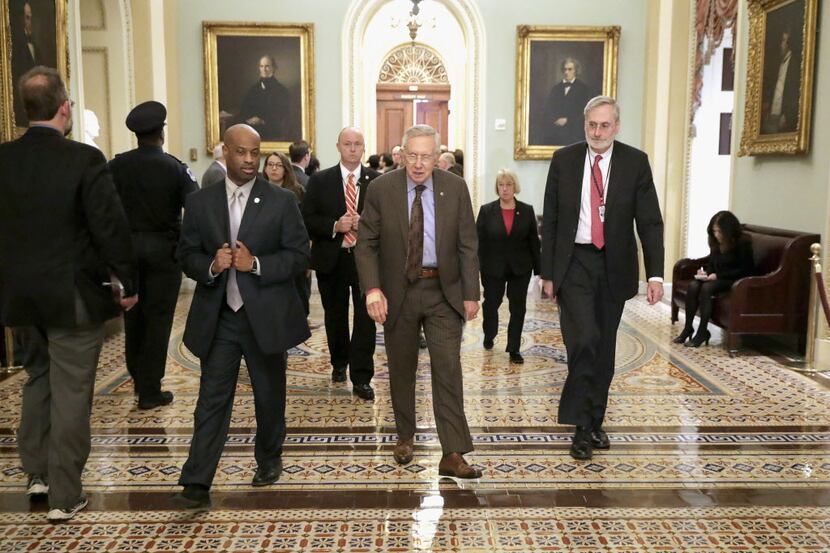 WASHINGTON, DC - APRIL 12:  Senate Minority Leader Harry Reid (D-NV) (C) leaves the weekly...