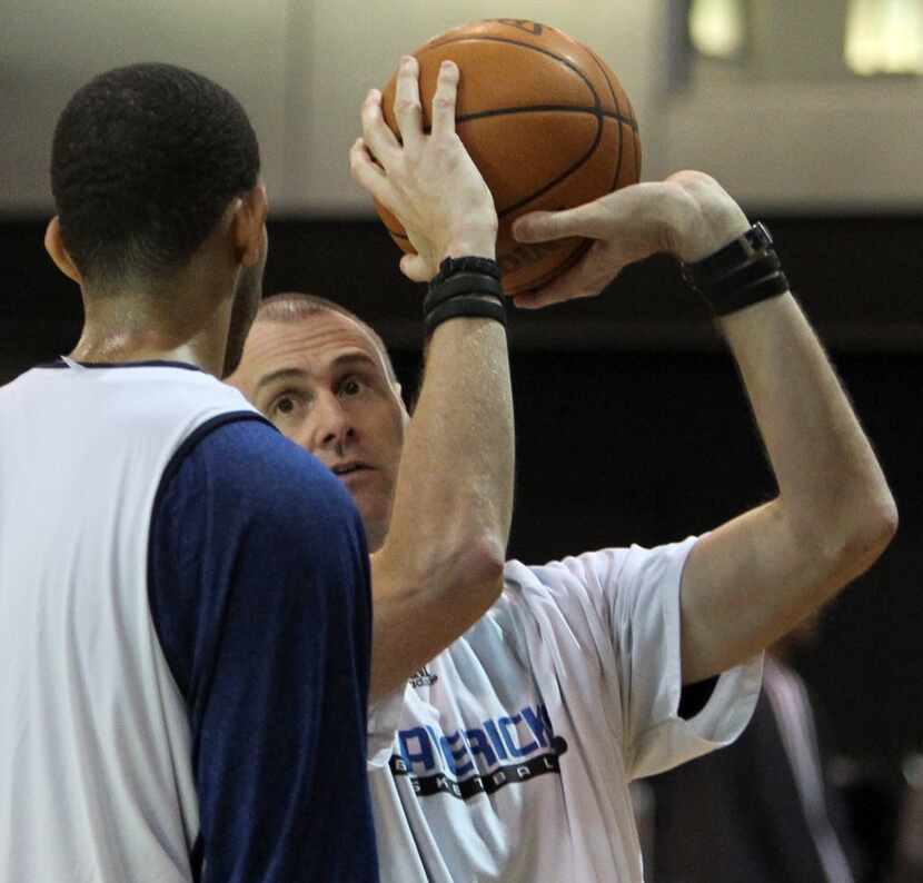 Dallas head coach Rick Carlisle, right, works with newcomer Brandan Wright on his shooting...