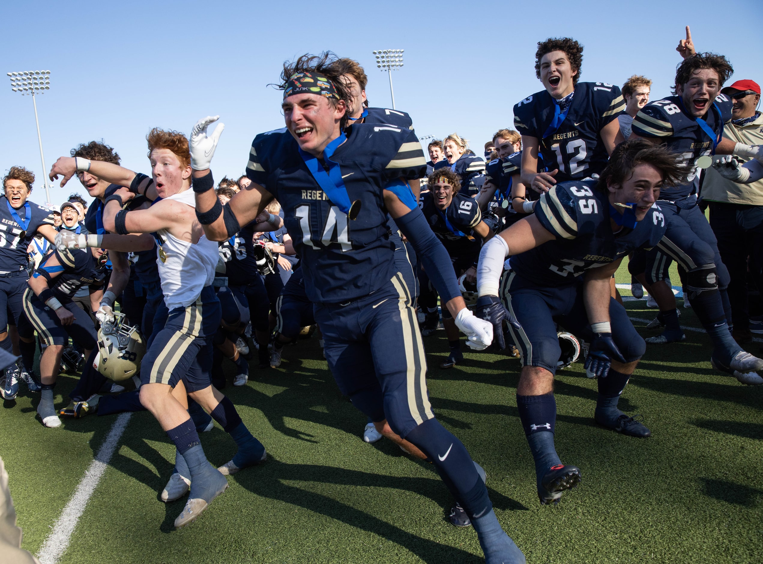 Austin Regents players celebrate after winning a TAPPS Division II state championship game...