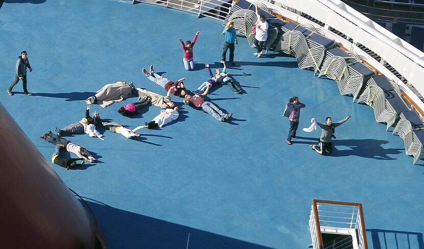 Passengers spelled out "HELP" as the Triumph was towed to harbor.