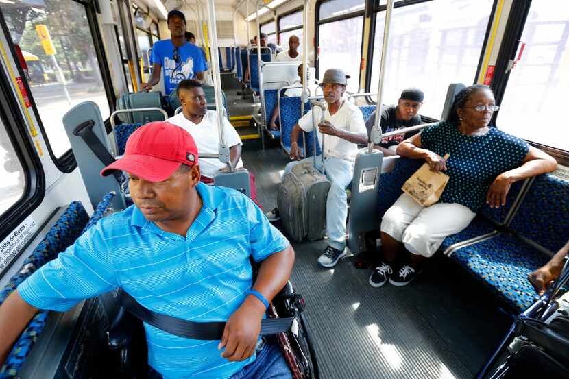 Riders take the DART bus to South Dallas on July 10, 2017. 