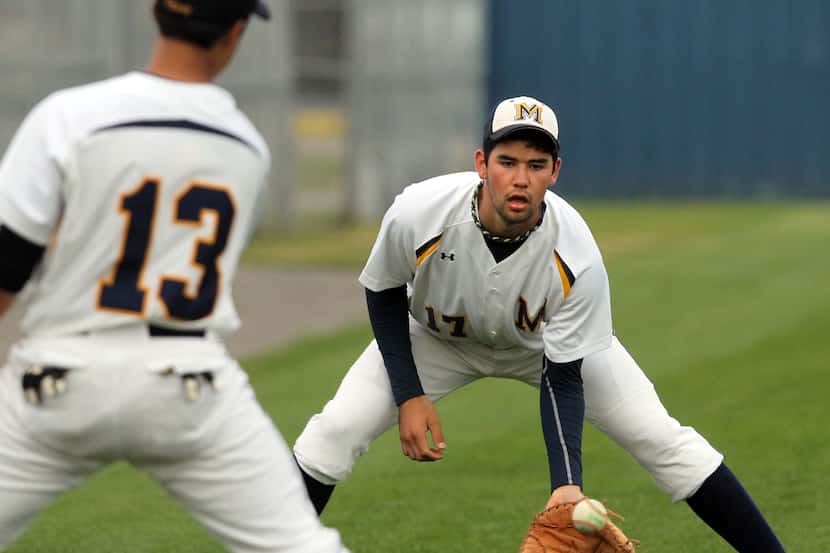 Mckinney High's Zach Lee (17) fields ball during a drill prior to the start of high school...