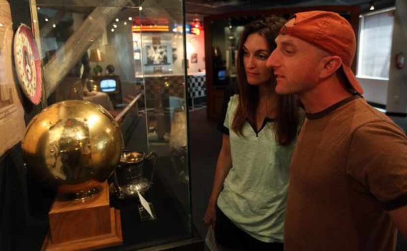 
Glenda Smith of Fort Worth and Chris Hayward of Boston check out items documenting women’s...