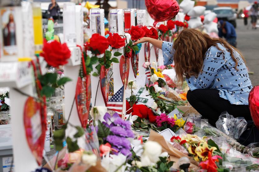 Gloria Garces of El Paso mourns for the loss of 2 family members at a makeshift memorial for...