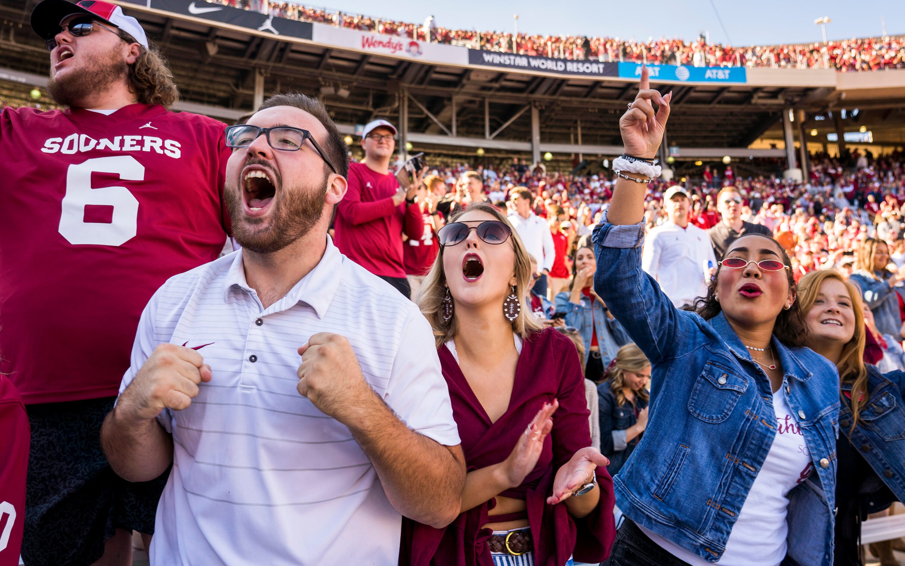 Oklahoma fans cheer their team before an NCAA football game against Texas at the Cotton Bowl...