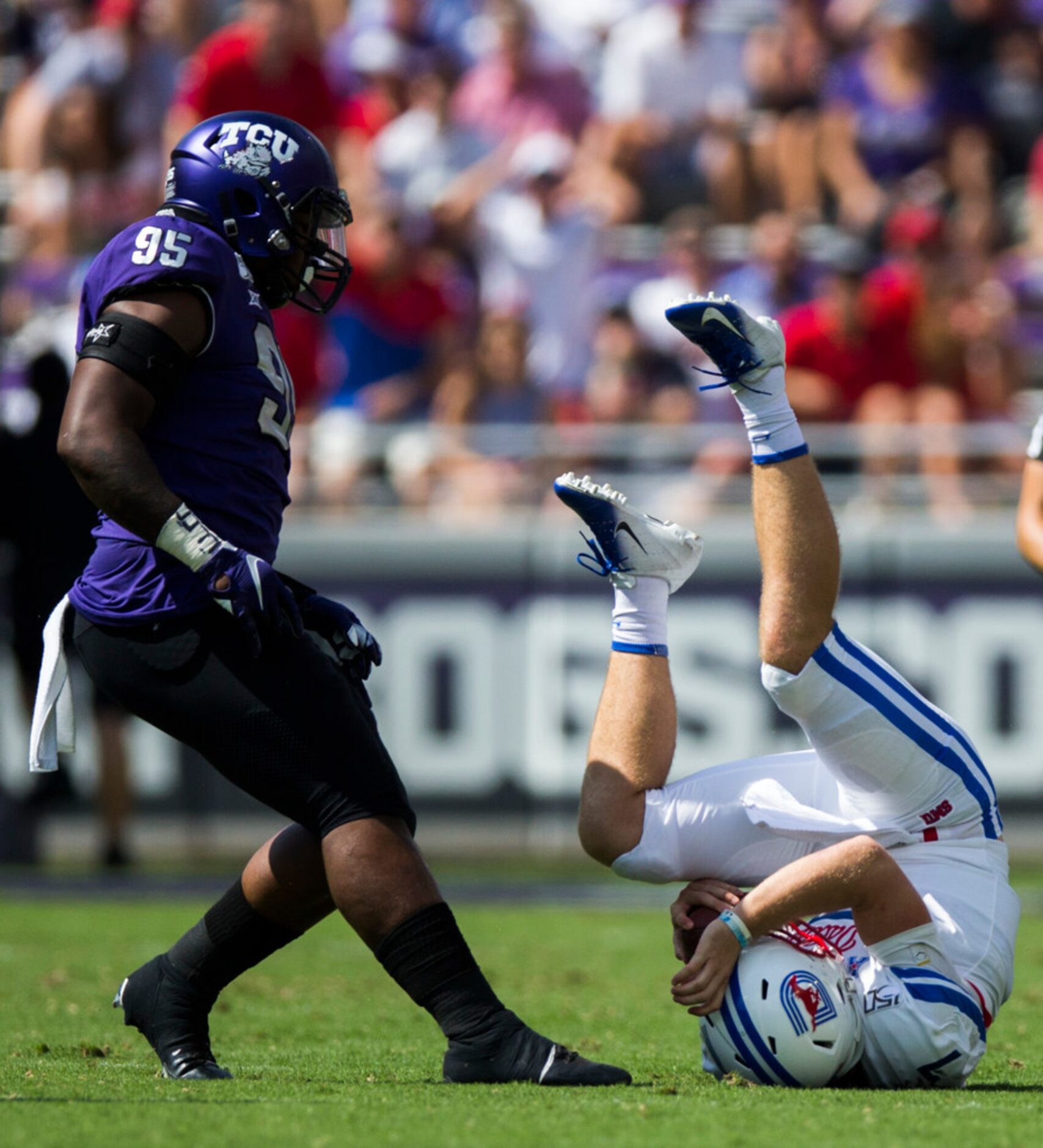 Southern Methodist Mustangs quarterback Shane Buechele (7) falls after a run next to TCU...