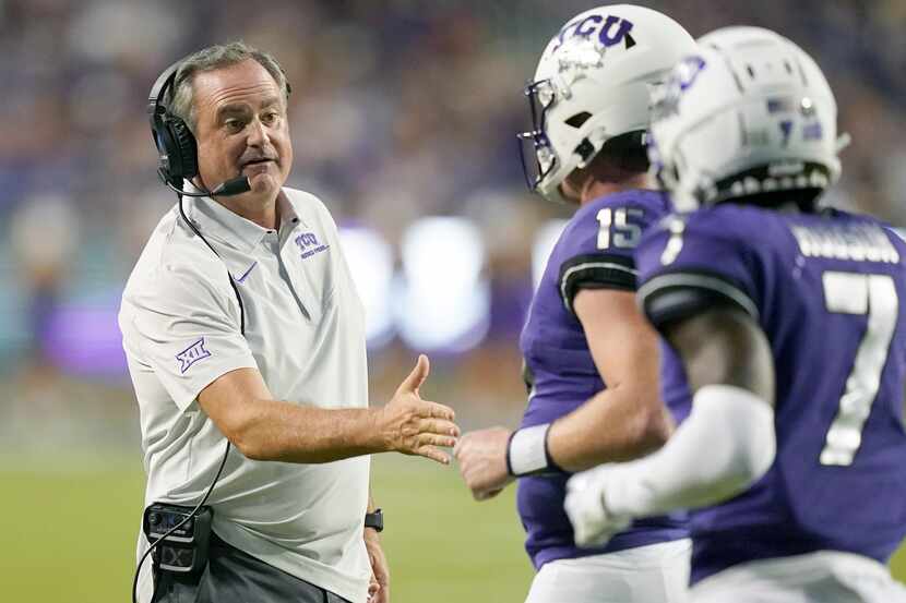 TCU head coach Sonny Dykes, left, congratulates quarterback Max Duggan (15) after a...