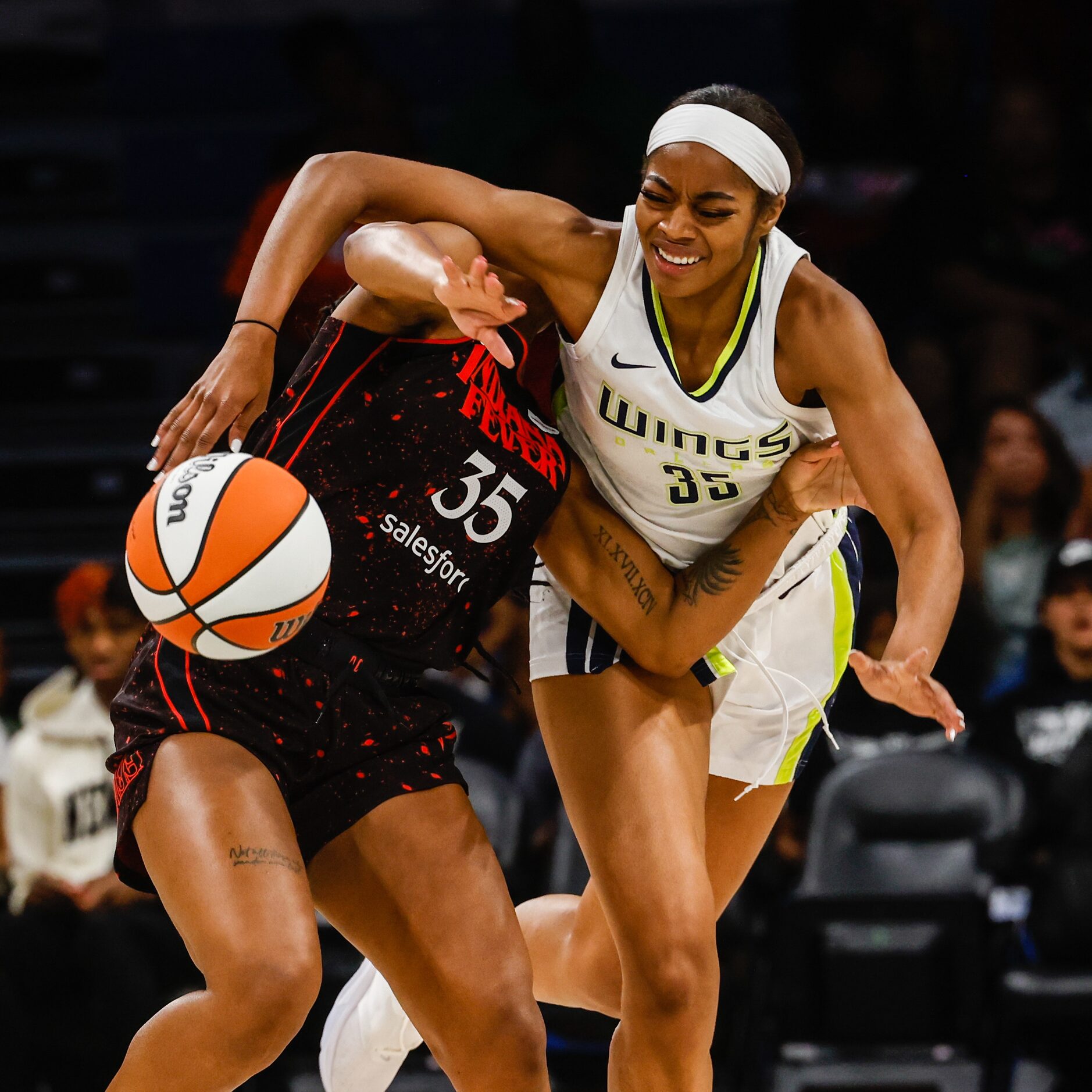 Dallas Wings forward Charli Collier (35) and Indiana Fever guard Victoria Vivians (35) get...