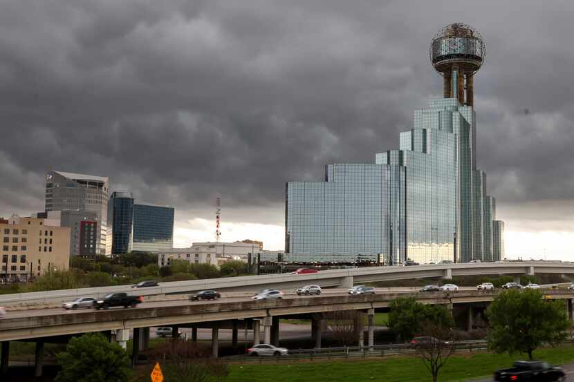 Storm clouds move over downtown Dallas as traffic moves along Interstate 35E on March 16.