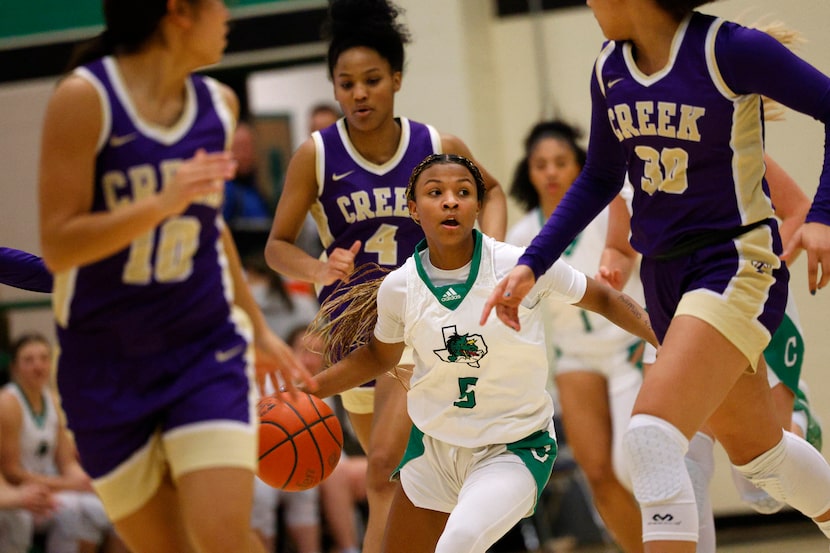 Southlake Carroll's Nadia Jordan (5) looks to pass against Keller Timber Creek's Elena...