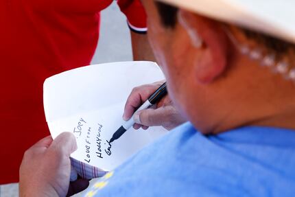 Guillermo Rodriguez signs an autograph for State Fair concessionaire Isaac Rousso. Rousso...