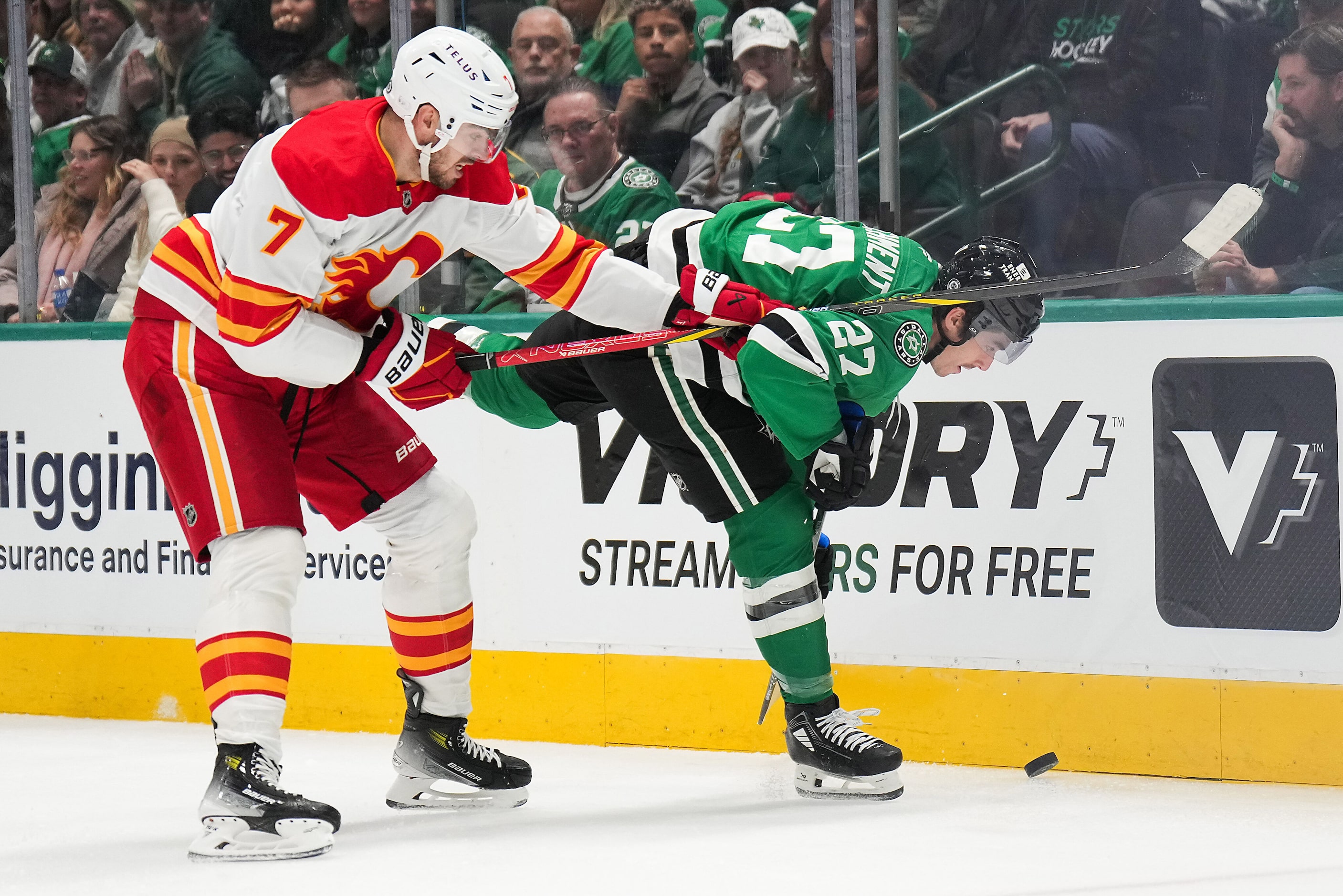 Dallas Stars left wing Mason Marchment (27) fights for the puck against Calgary Flames...