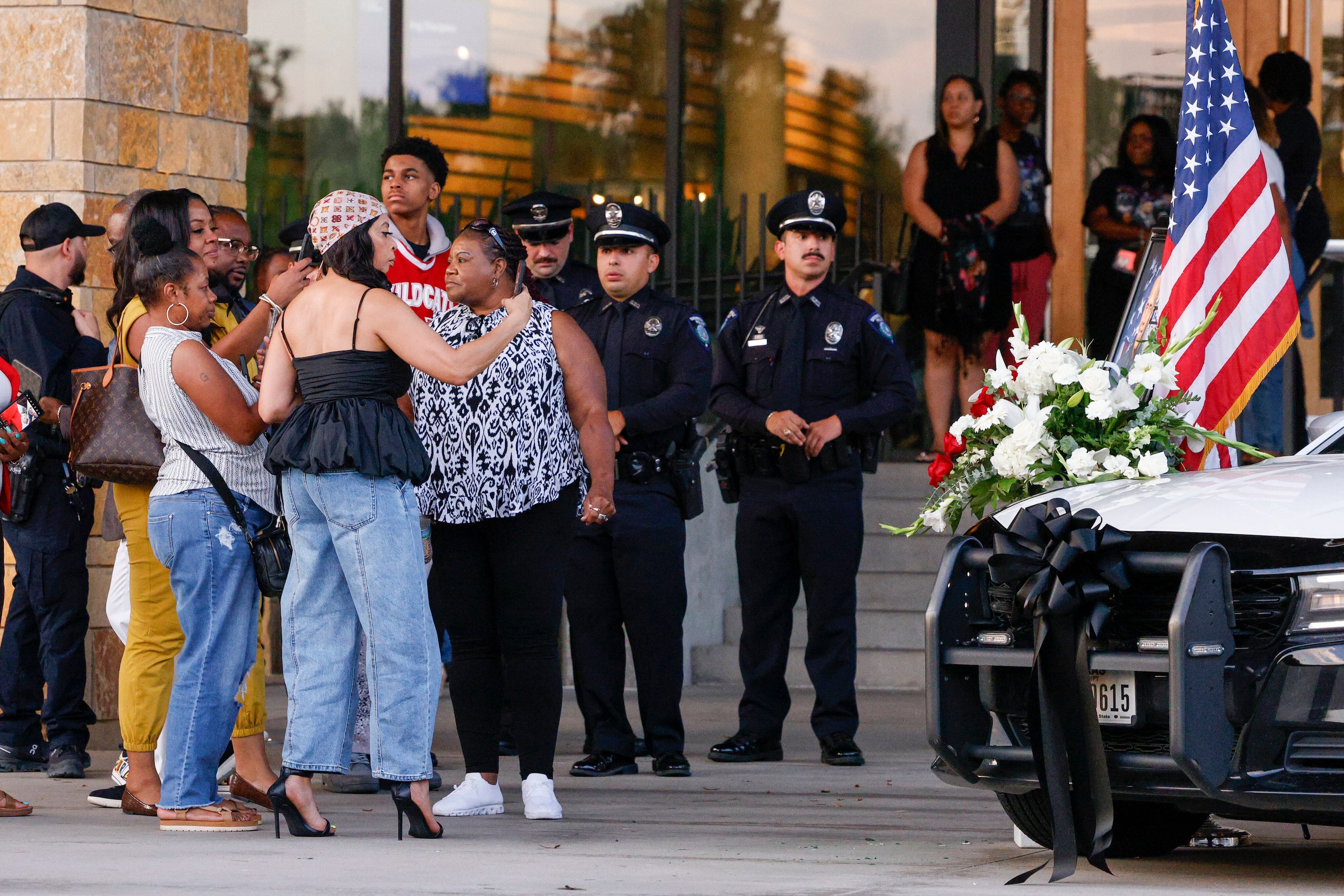 People take photos of a memorial setup for Dallas police Officer Darron Burks outside...