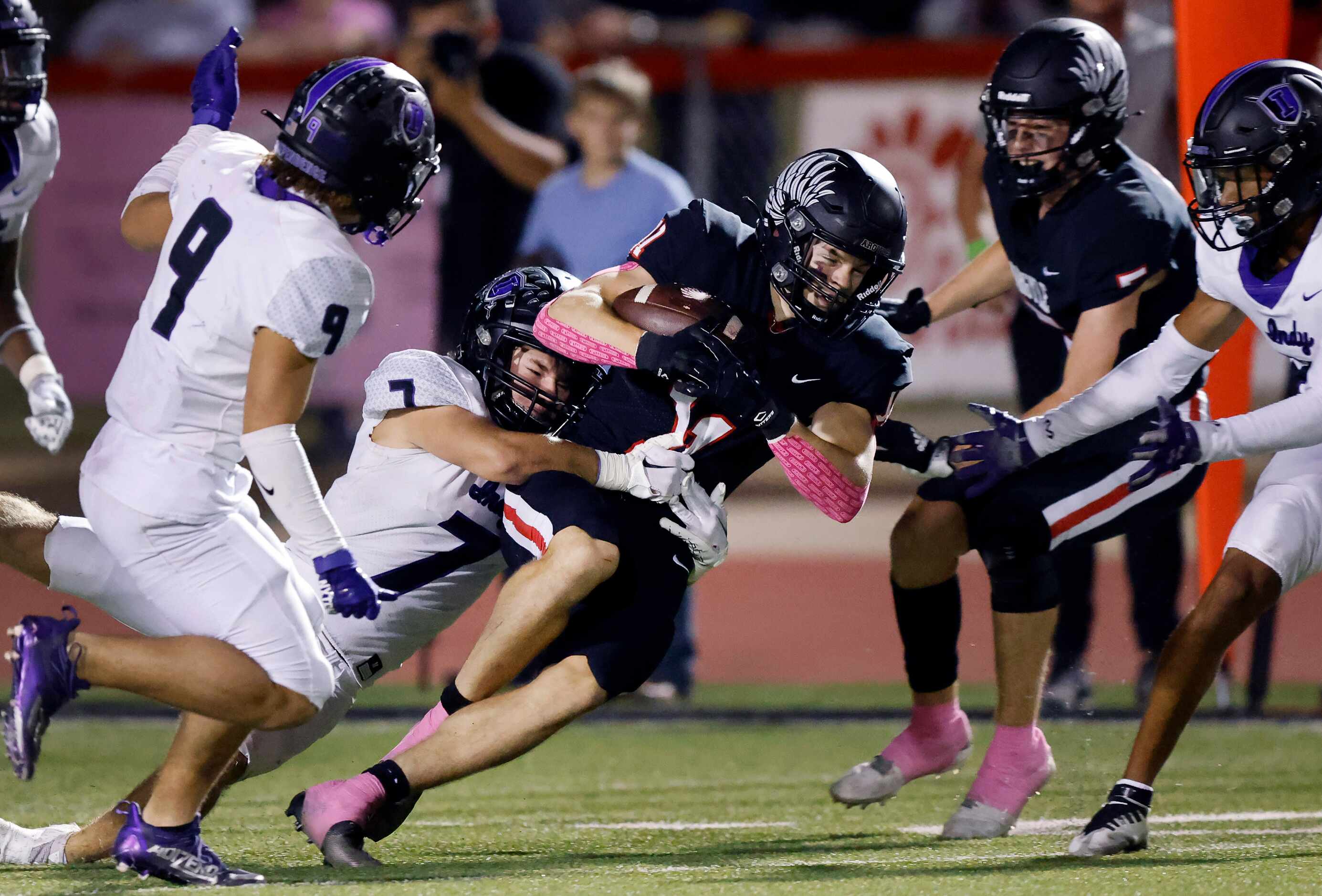 Argyle running back RJ Bunnell (11) drives for extra yards as he is dragged down from behind...