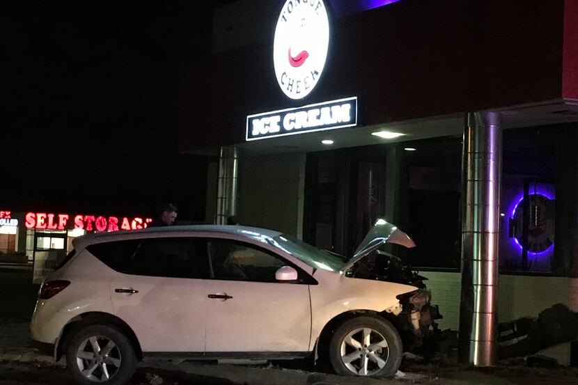 A white SUV was damaged when it struck a Richardson ice cream shop after a brief police...