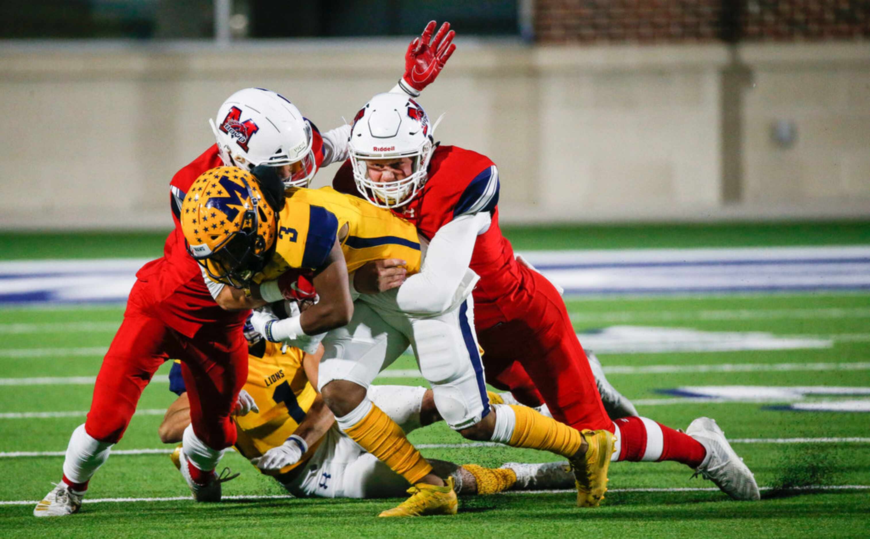 McKinney's Isaiah Wallace (3) and Isaiah Rojas (1) are brought down by McKinney Boyd's Caden...