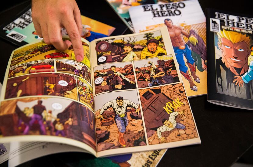 Hector Rodriguez, fifth-grade teacher and creator of El Peso Hero comic book, points out a...