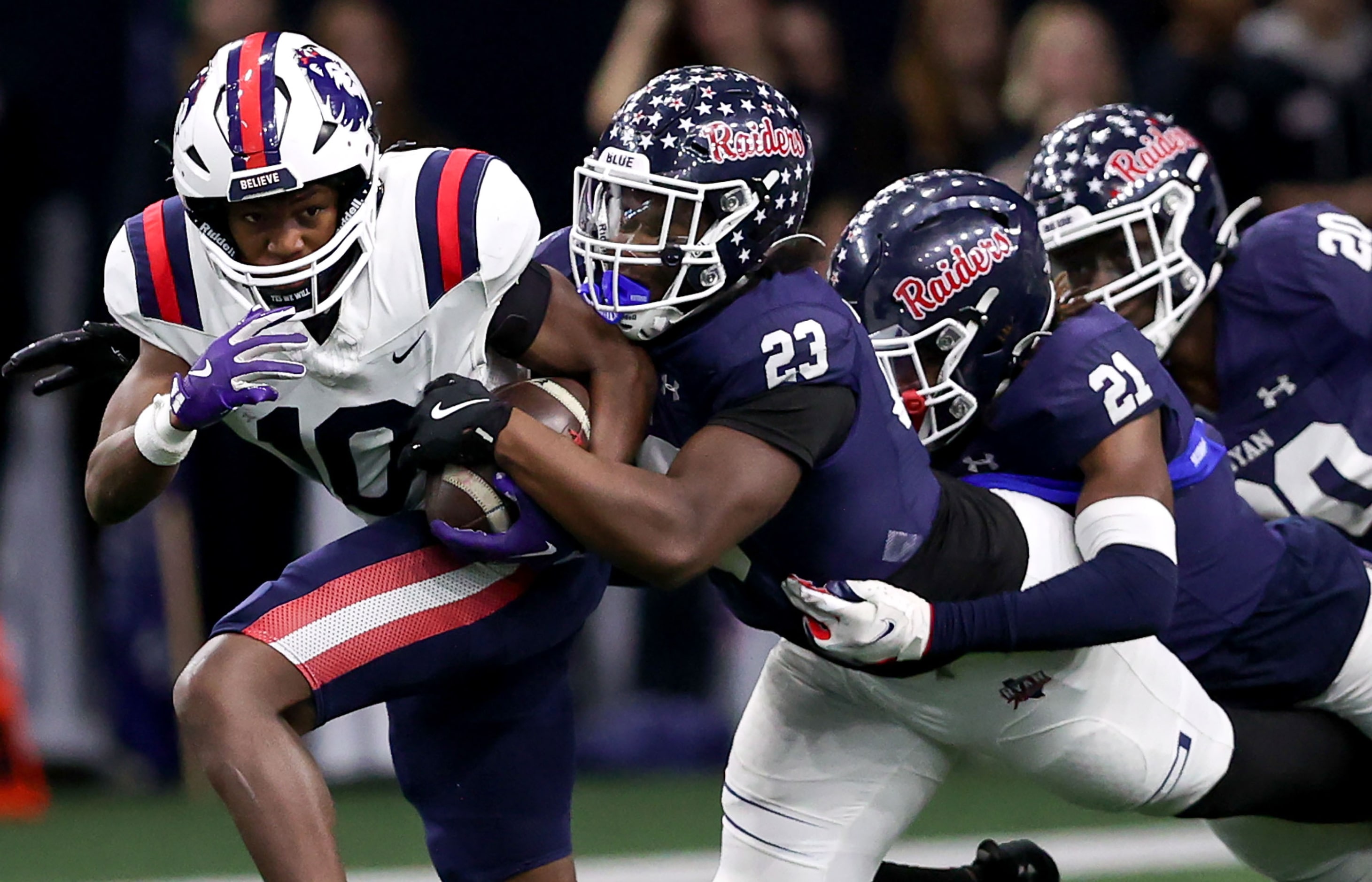 Richland running back Jayshon Gibson (10) tries to fight for yardage against Denton Ryan...