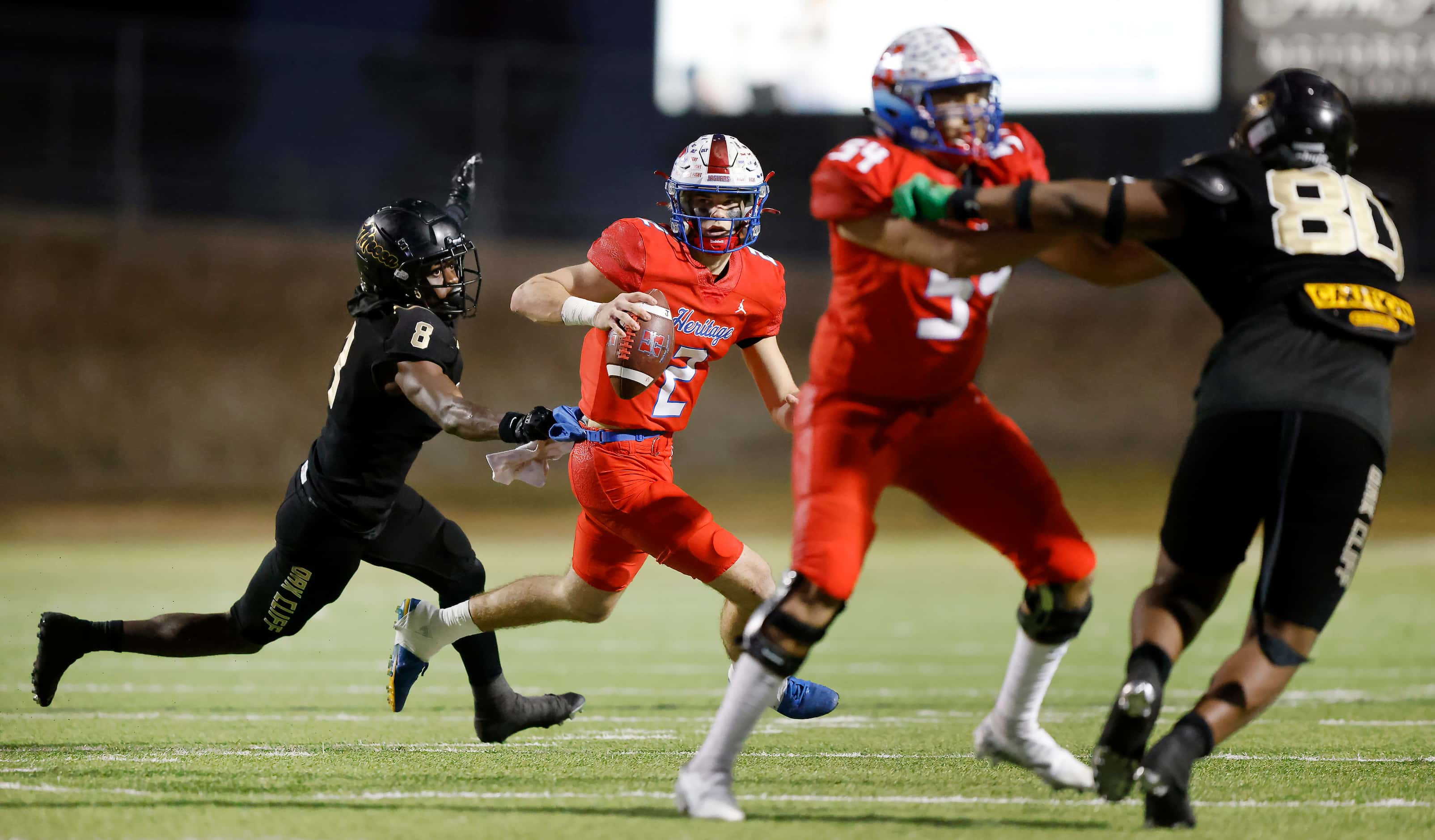 Midlothian Heritage quarterback Kaden Brown (2) is chased down and tackled by South Oak...
