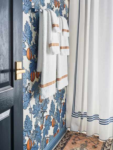 In a bathroom in McGaha's home, white towels have a colorful stripe accent — similar to the...