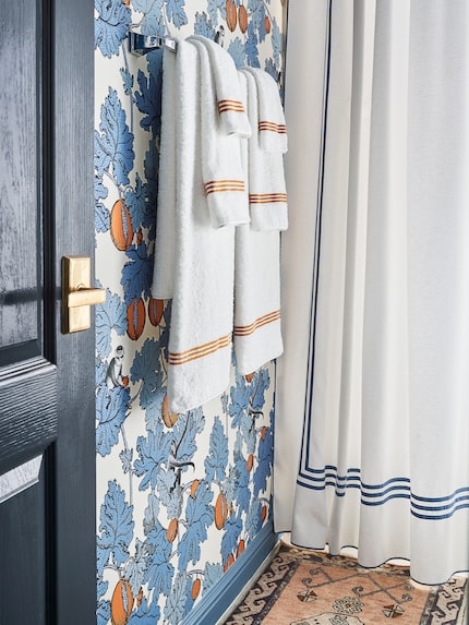 In a bathroom in McGaha's home, white towels have a colorful stripe accent — similar to the...