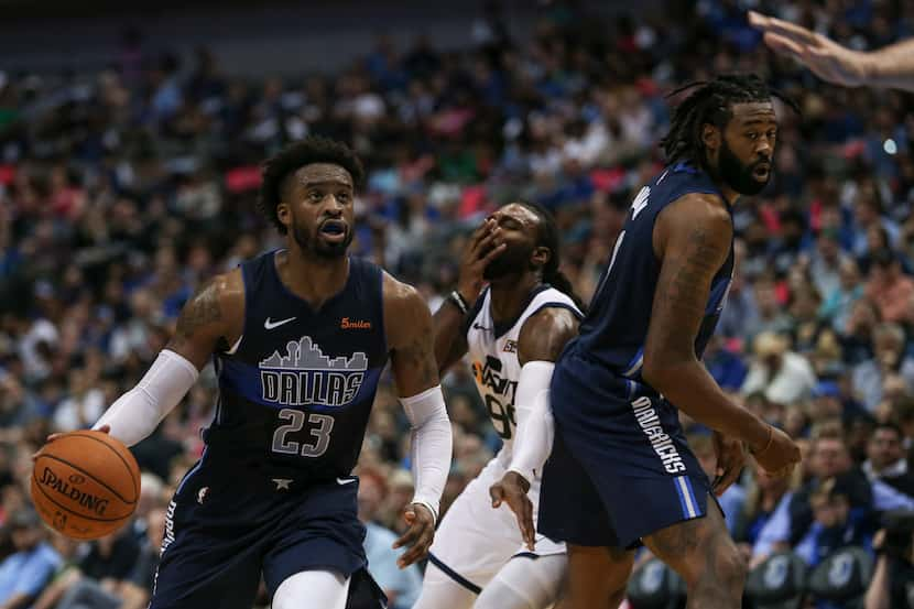 Utah Jazz forward Jae Crowder (99, background center) grimaces after being hit by Dallas...