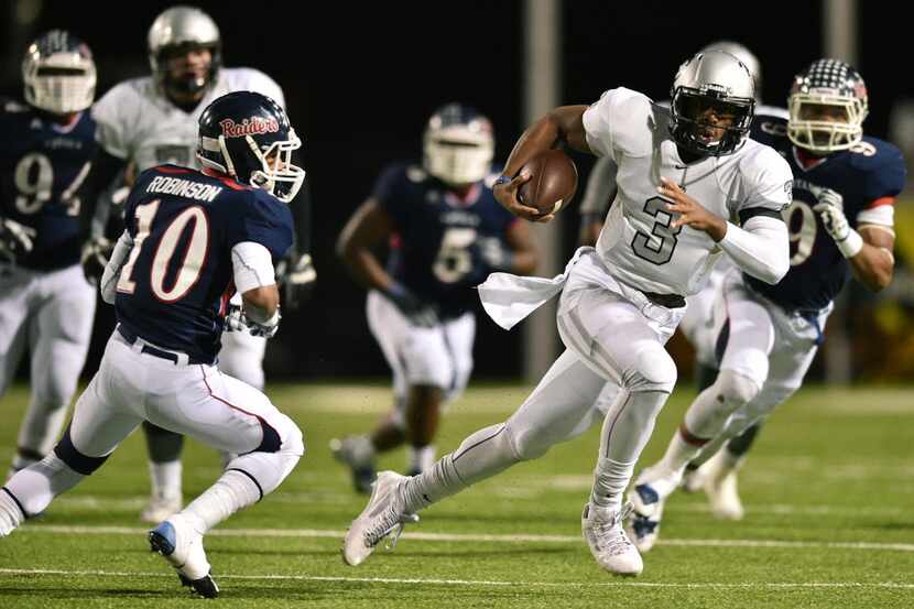 Guyer sophomore quarterback Shawn Robinson (3) looks for an opening on the run against Ryan,...