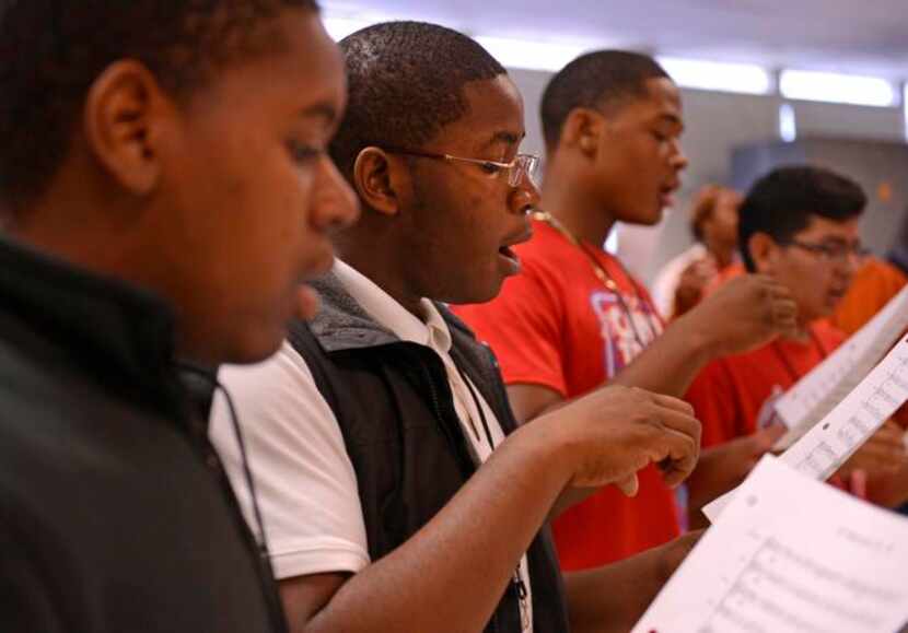 
Sophomore Kenoly Kadia (center) sings during a choir practice at David W. Carter High School.
