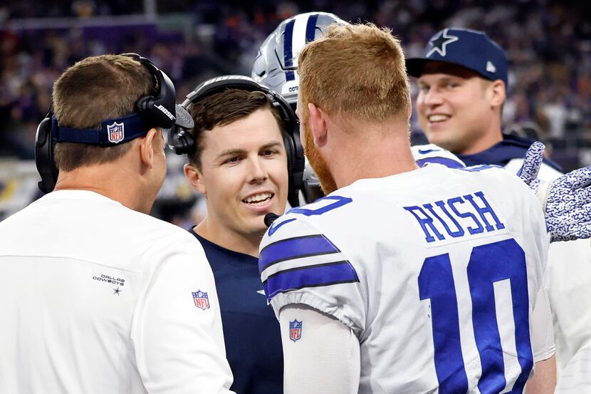 Dallas Cowboys offensive coordinator Kellen Moore (center) congratulates quarterback Cooper...