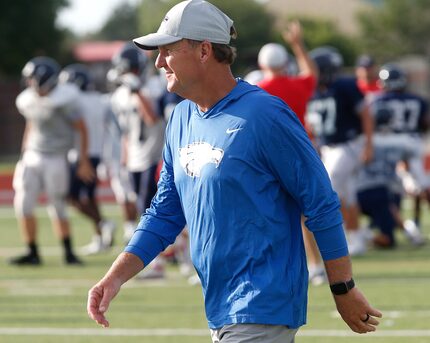 Allen High School head football coach Chad Morris observes the freshman practice while Allen...