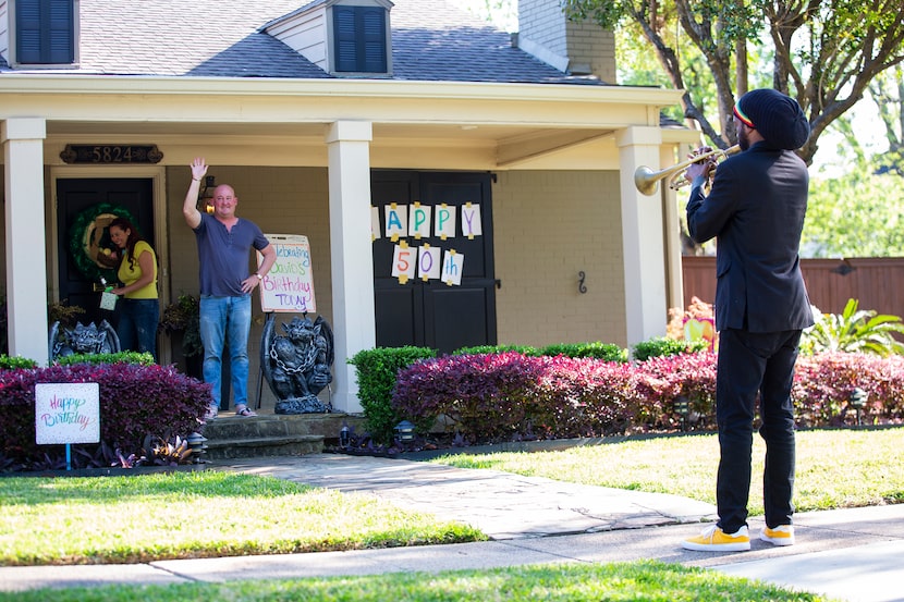 Trumpeter Alcedrick Todd (right) performs for David Hannah's 50th birthday outside of his...