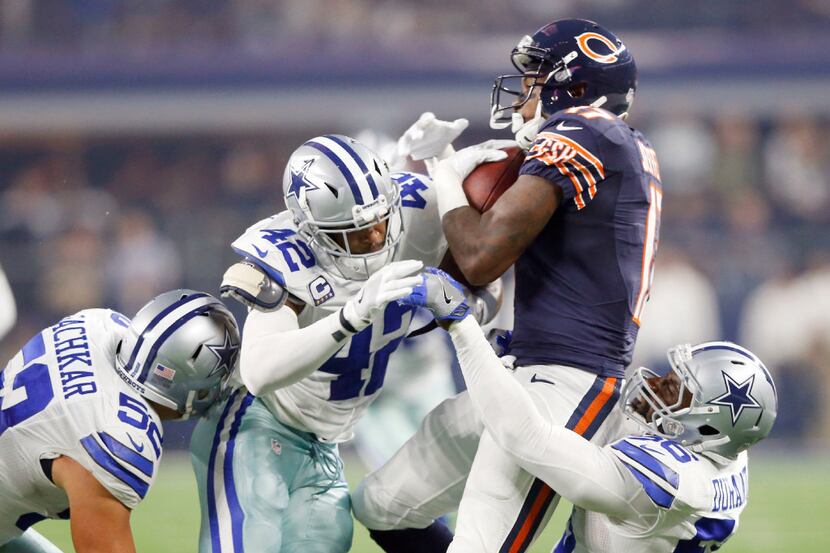 Chicago Bears wide receiver Alshon Jeffery (17) is brought down by Dallas Cowboys strong...