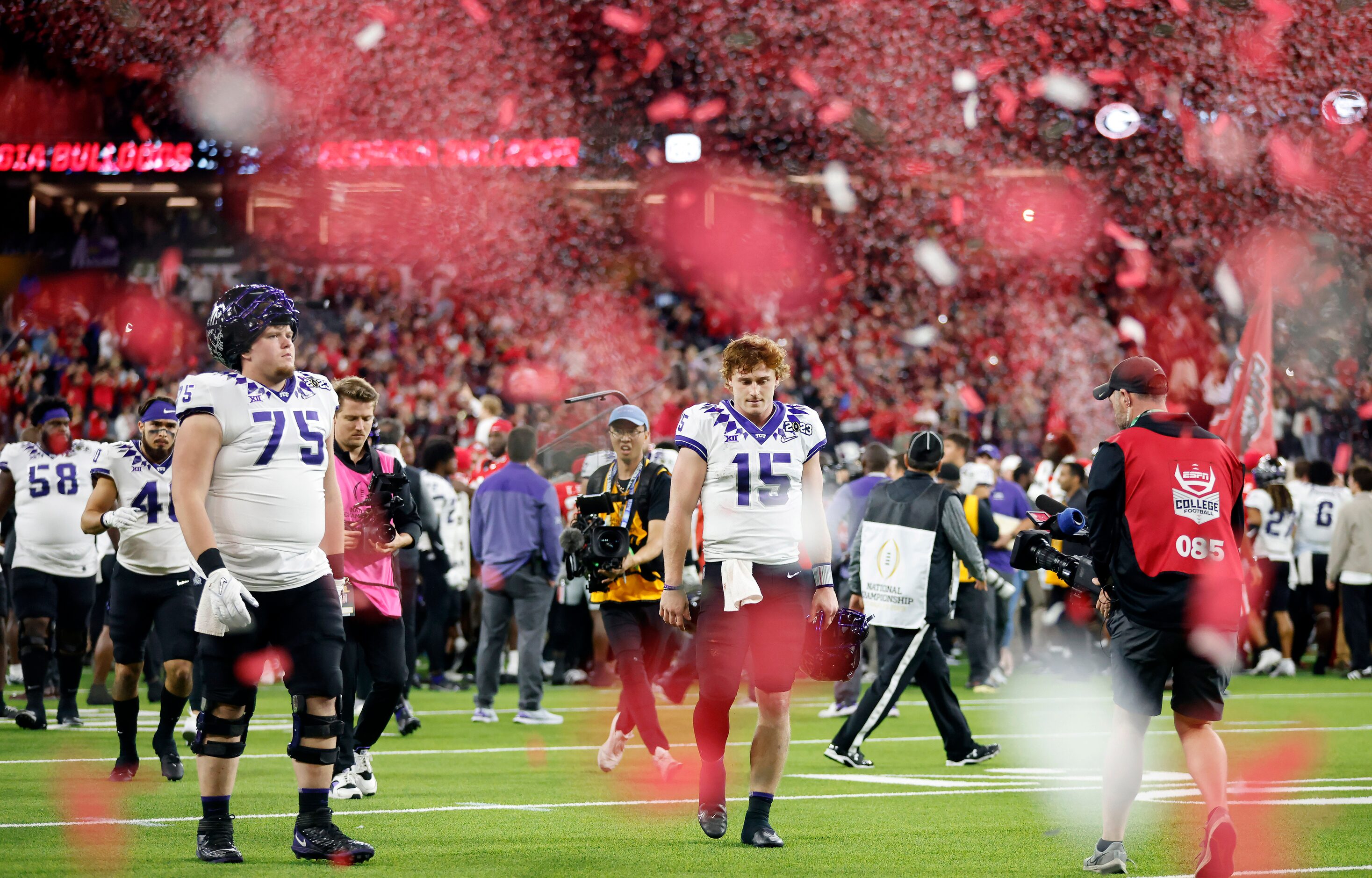 As Georgia Bulldogs red confetti rains down, TCU Horned Frogs quarterback Max Duggan (15)...