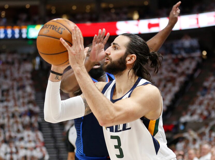 Utah Jazz guard Ricky Rubio (3) shoots as Oklahoma City Thunder guard Raymond Felton, rear,...