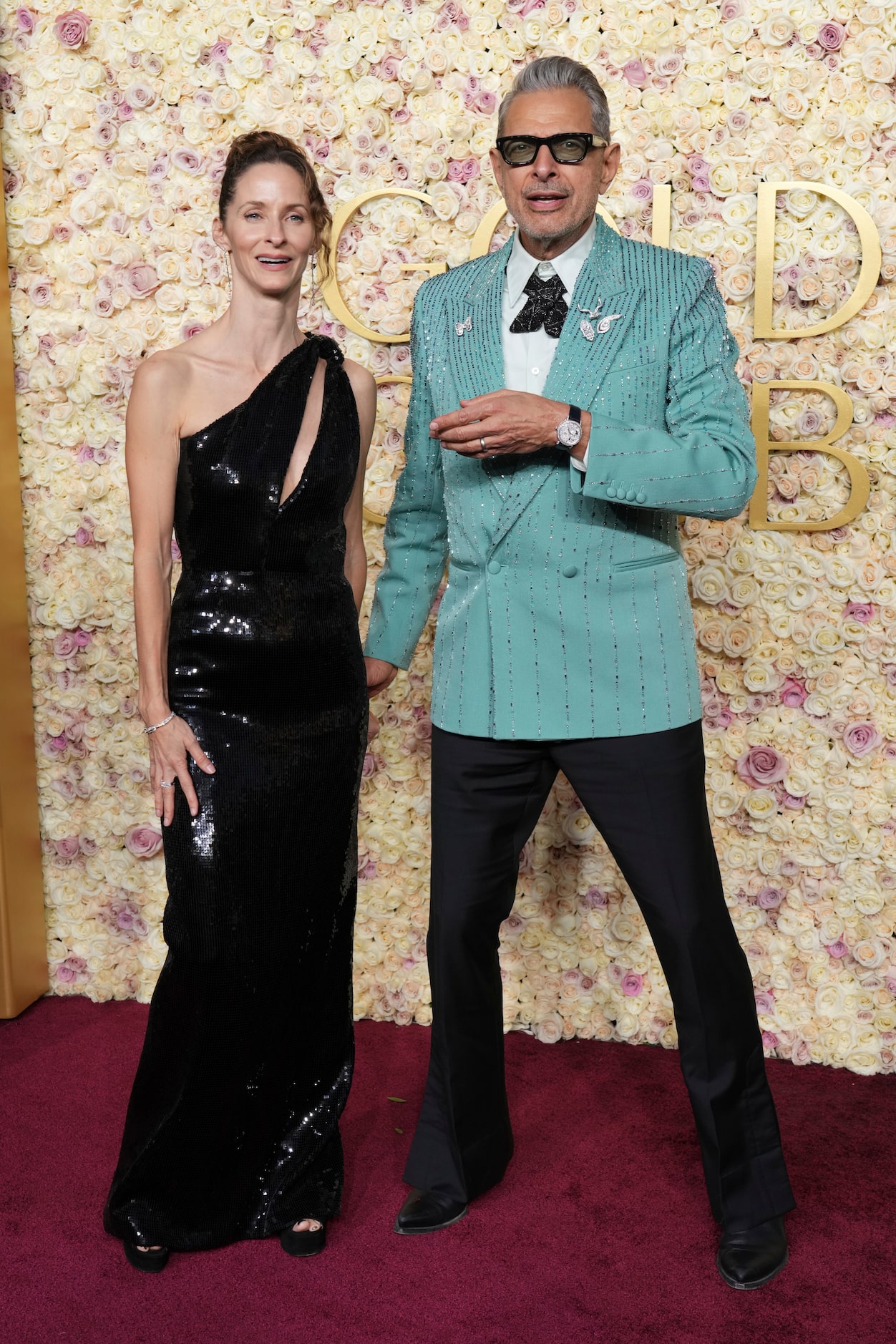 Emilie Livingston, left, and Jeff Goldblum arrive at the 82nd Golden Globes on Sunday, Jan....