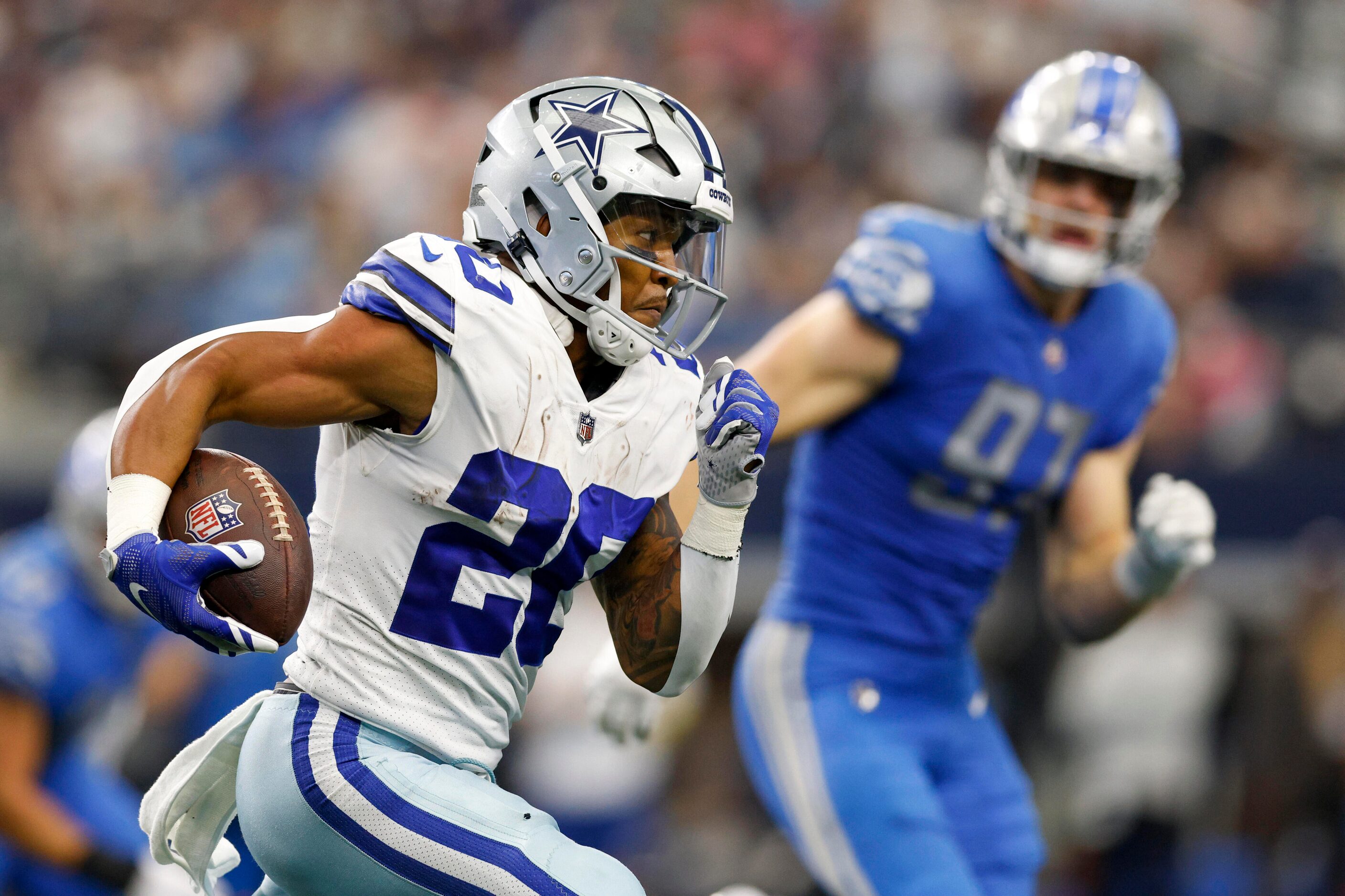 Dallas Cowboys running back Tony Pollard (20) runs after a catch during the fourth quarter...