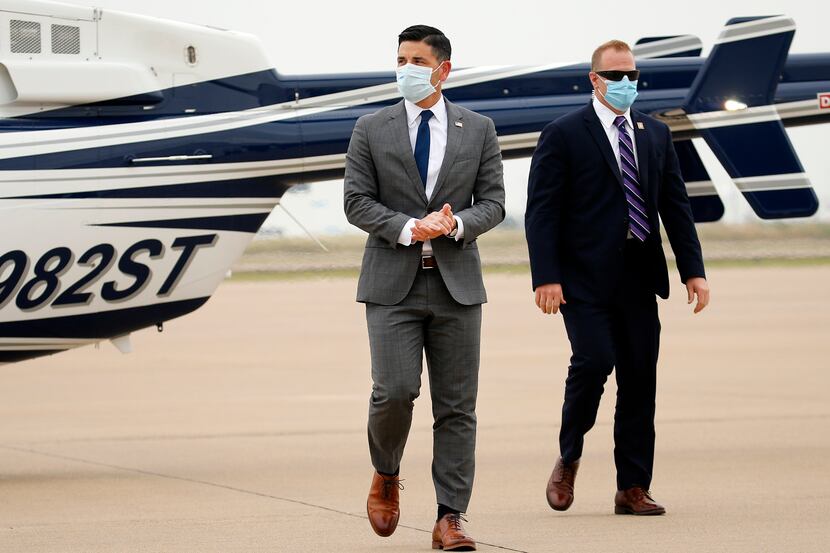 Acting Secretary of Homeland Security Chad Wolf (left) gets off a helicopter after receiving...