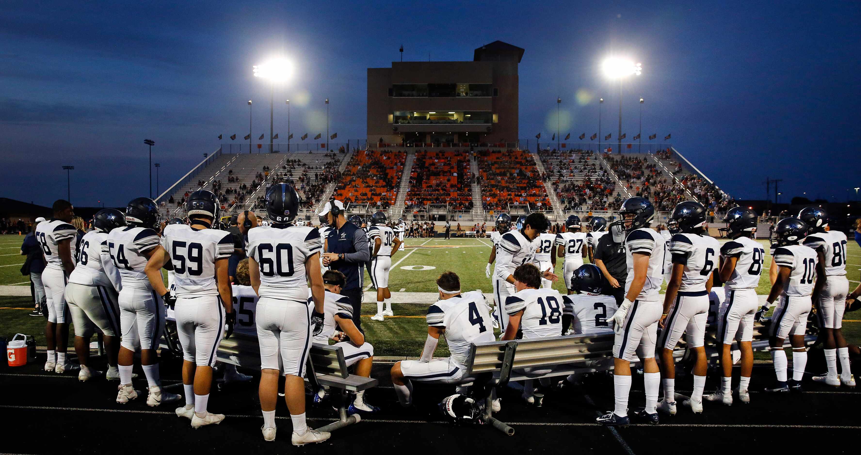The Frisco Lone Star football team huddles up on the bench as they face Aledo in the first...