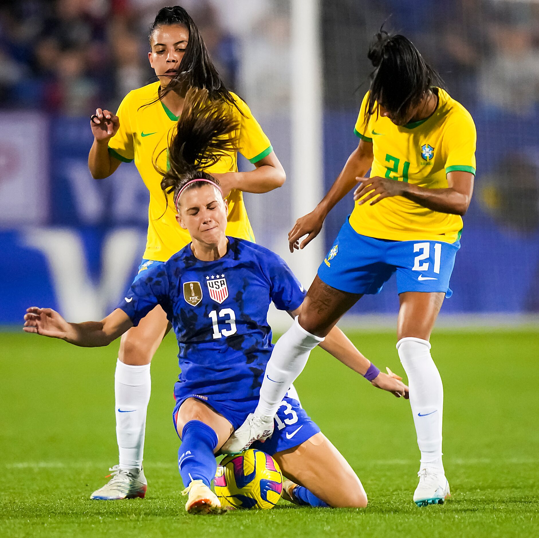 United States forward Alex Morgan (13) fights for the ball against Brazil midfielder Kerolin...