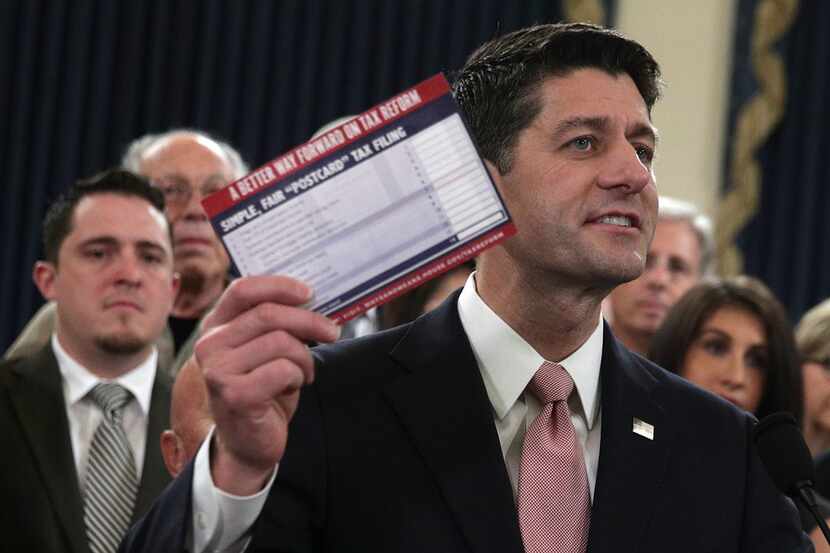Speaker of the House Rep. Paul Ryan (R-WI) holds up a postcard size tax return form during a...