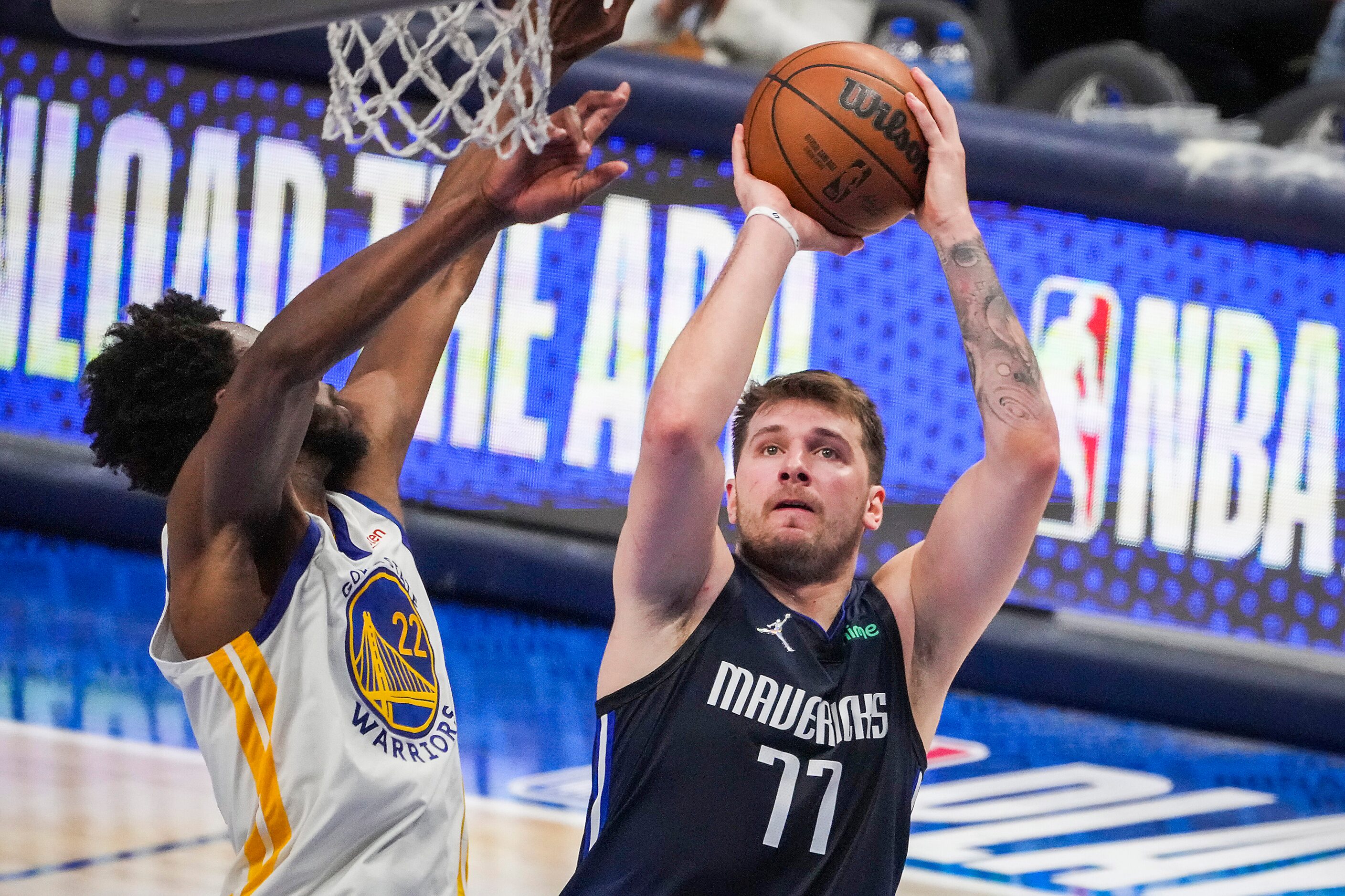 Dallas Mavericks guard Luka Doncic (77) scores past Golden State Warriors forward Andrew...