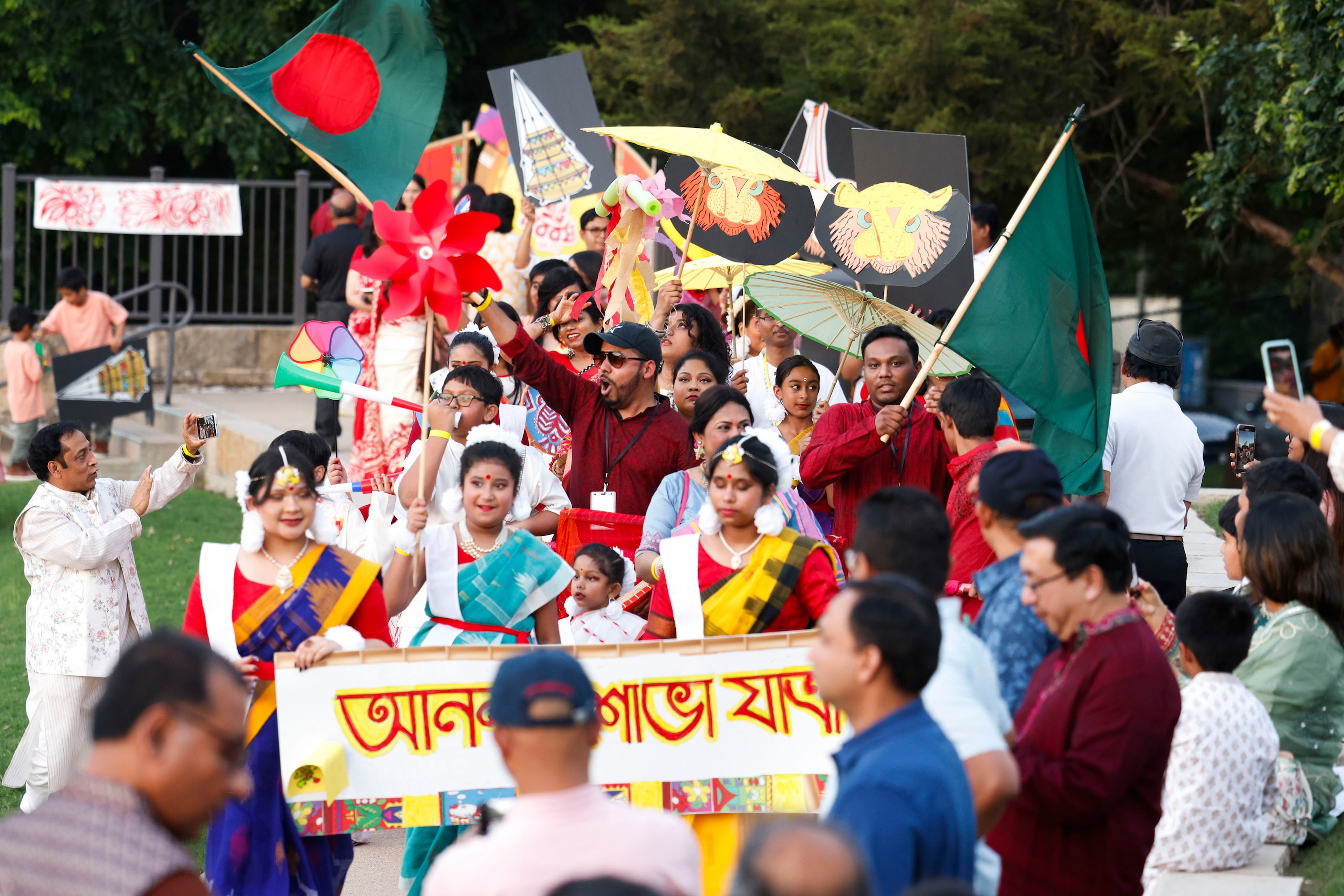 Bangladesh Association Of North Texas members carry out a procession around Red Tail...