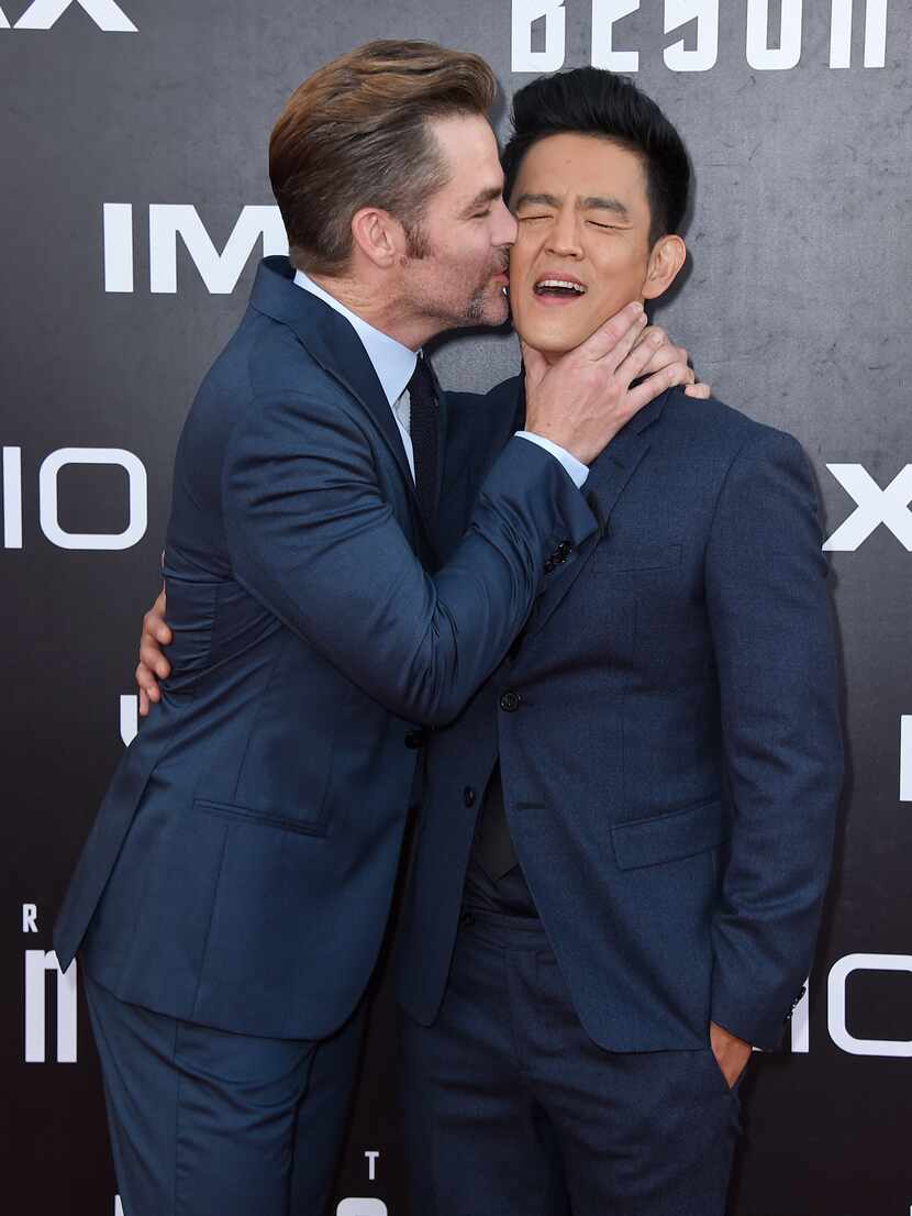 Chris Pine, left, kisses John Cho as they arrive at the world premiere of "Star Trek Beyond"...