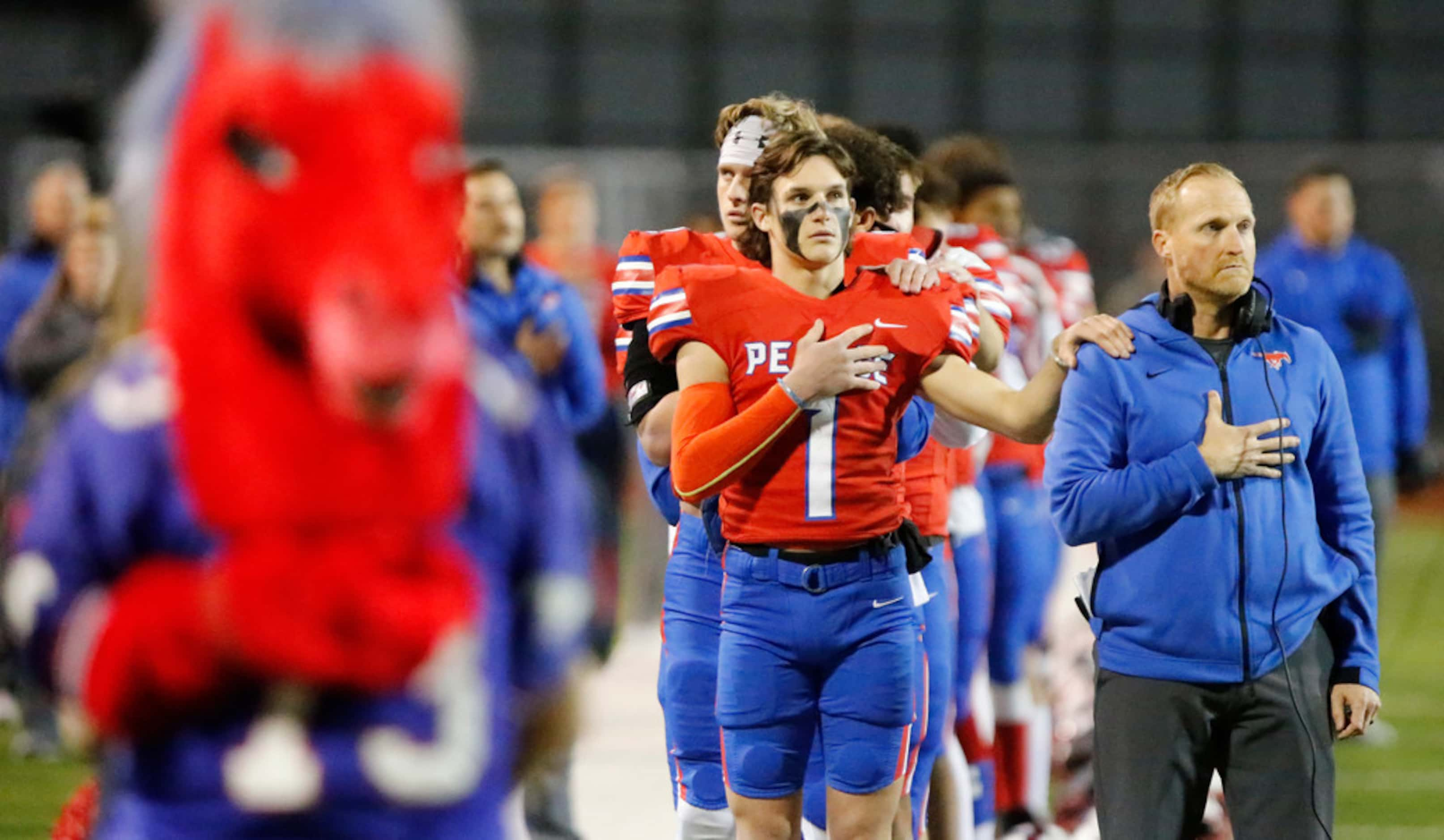 J.J. Pearce High School wide receiver Sutton Stokes (1) stands at attention with J.J. Pearce...