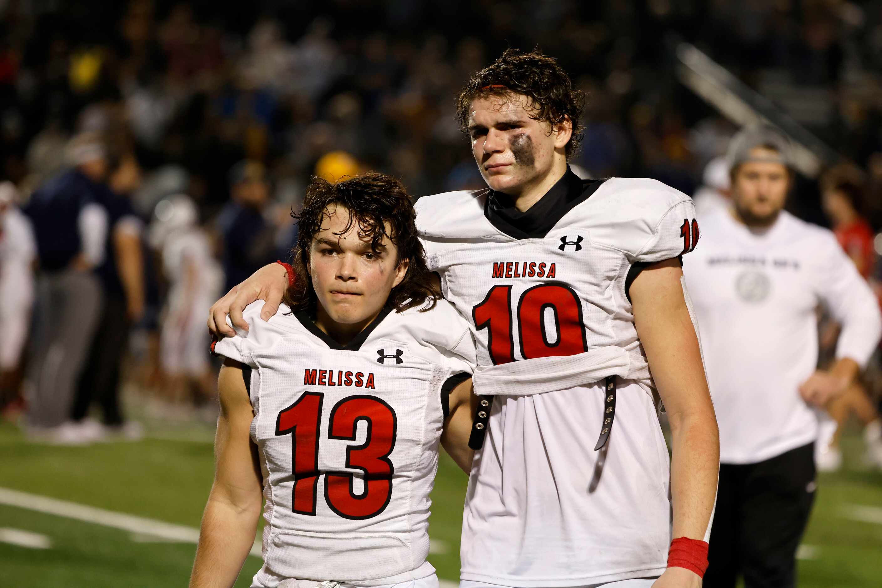 Melissa wide receivers Jacob Kusano (13) and Matthew Sanford embrace after they lost to...