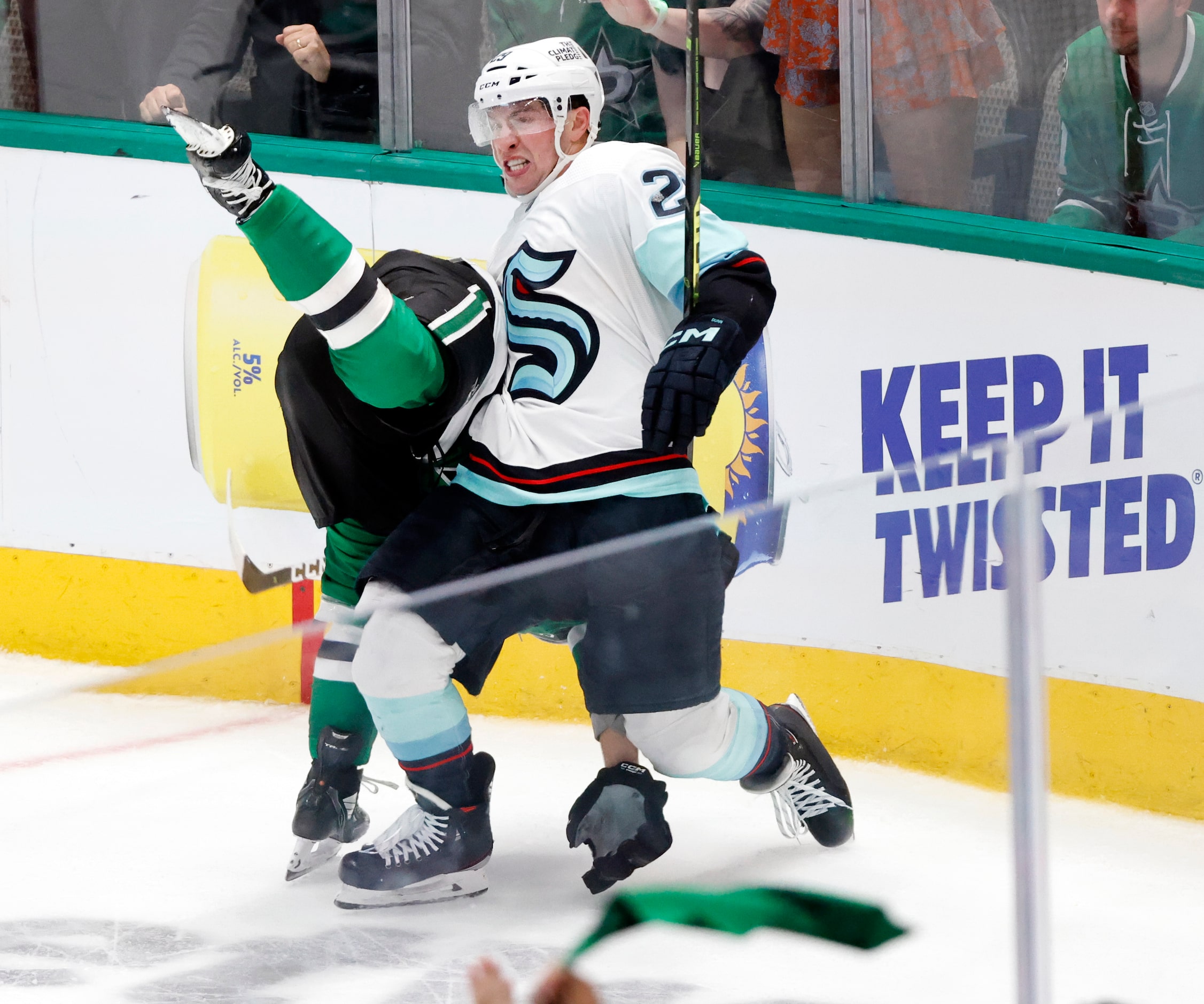 Seattle Kraken defenseman Vince Dunn (29) takes down Dallas Stars center Wyatt Johnston (53)...